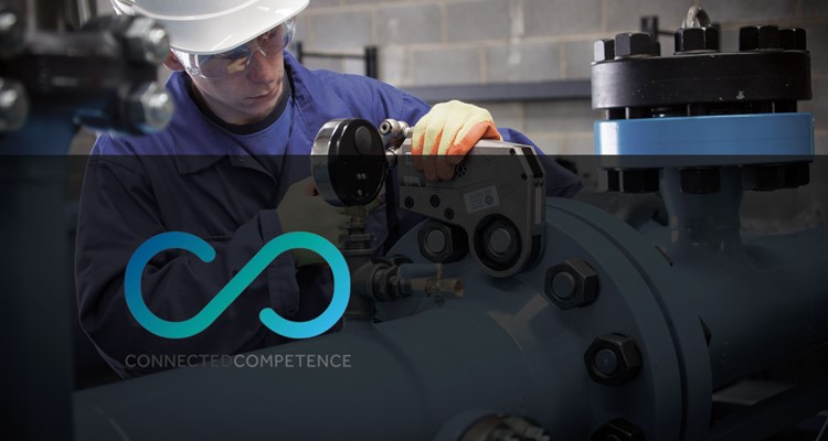 A worker in protective gear operates machinery in an industrial setting, with the Connected Competence logo and text at the forefront.